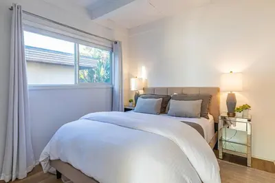 a white bedroom with a bed and a window at Malibu Best Kept Secret in Malibu