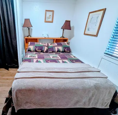 a bedroom with a large bed with two pillows at Fox n Bear Cottages Big Bear in Big Bear Lake