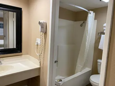 a bathroom with a phone next to a sink at The Dixie Orange County in Stanton