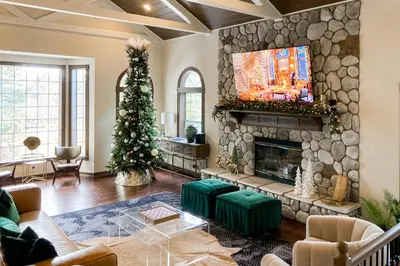a living room with a fireplace and a christmas tree at The Chateau in Lake Arrowhead