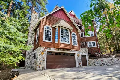 a large wooden house with a garage at The Chateau in Lake Arrowhead