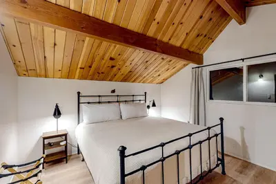 a bedroom with a bed with a wooden ceiling at Pinecrest Paradise in Crestline