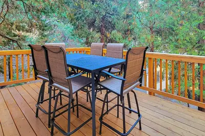 a blue table and four chairs on a deck at Pinecrest Paradise in Crestline