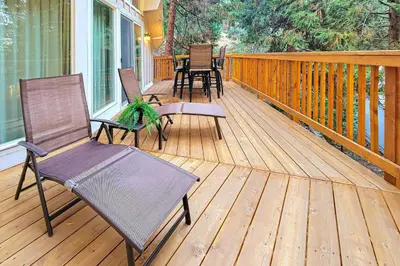 a wooden deck with chairs and a table on it at Pinecrest Paradise in Crestline