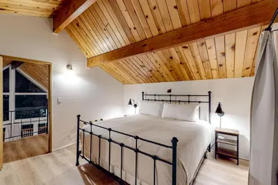 a bedroom with a bed with a wooden ceiling at Pinecrest Paradise in Crestline