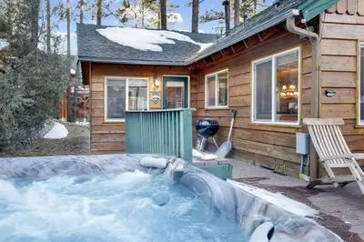 a house with a hot tub in front of it at Big Bear Happy Place~ Hot Tub~ Games~ Walk to Village~ in Big Bear Lake