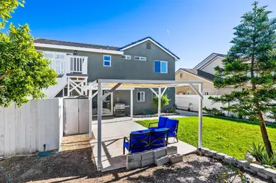 a house with two blue chairs in the yard at Olivia Oasis in Oxnard