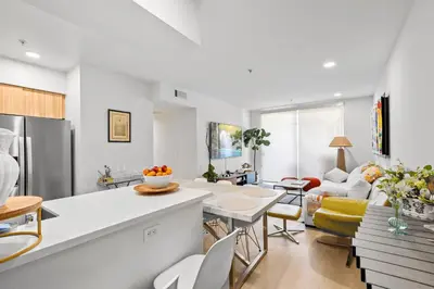 a kitchen and living room with a table and chairs at 9 Advantages Center Santa Manica in Los Angeles