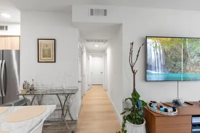 a hallway of a home with a waterfall painting on the wall at 9 Advantages Center Santa Manica in Los Angeles