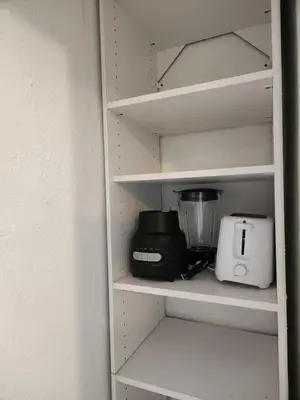 a kitchen shelf with a blender and a toaster at Eight Street Apartments in Long Beach