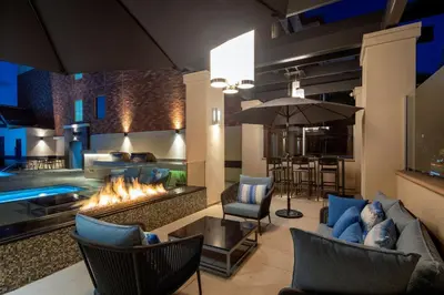 a living room with a fireplace and a pool at Super Quiet Apartment In Full Service Bldg near UCLA in Los Angeles