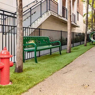 a green park bench next to a fence with a fire hydrant at Super Quiet Apartment In Full Service Bldg near UCLA in Los Angeles