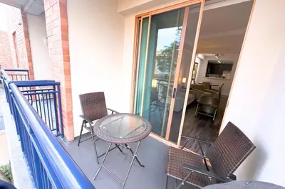 a balcony with a table and chairs on a porch at Stylish 2 Bed 2.5 Bath Condo Near Beverly Hills. in Los Angeles