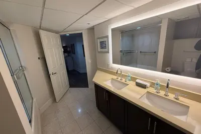 a bathroom with two sinks and a large mirror at Stylish 2 Bed 2.5 Bath Condo Near Beverly Hills. in Los Angeles