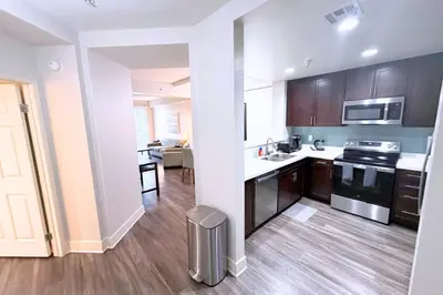 a kitchen with brown cabinets and a stove top oven at Stylish 2 Bed 2.5 Bath Condo Near Beverly Hills. in Los Angeles