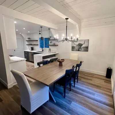 a dining room table and chairs in a kitchen at Lake Arrowhead Lux Black Cabin in Lake Arrowhead