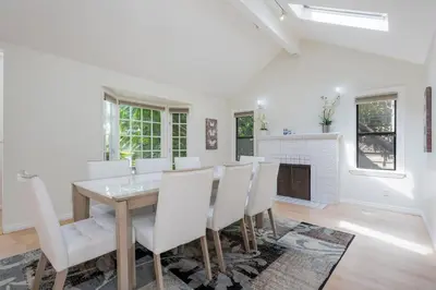 a dining room with a table and chairs and a fireplace at Large 5 BR- Beverly Hills Adj in Los Angeles