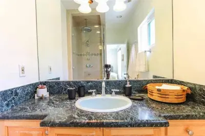 a bathroom with a sink and a large mirror at Large 5 BR- Beverly Hills Adj in Los Angeles