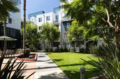 a courtyard of a building with a lawn and trees at Playa Vista 1BR w Pool Gym Spa nr the beach LAX-138 in Los Angeles