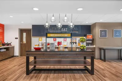 a lobby of a restaurant with a counter with food at Hampton Inn & Suites Bakersfield Central in Bakersfield