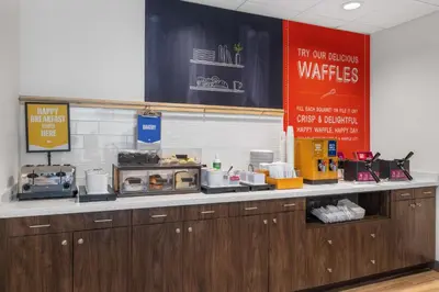 a kitchen with a counter with aasteryasteryasteryasteryasteryasteryasteryasteryastery at Hampton Inn & Suites Bakersfield Central in Bakersfield