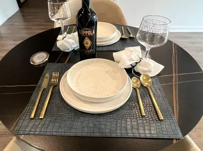 a black table with a plate and a bottle of wine at NEW One Bedroom Penthouse, Silver Lake + Parking! in Los Angeles