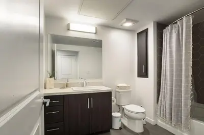 a bathroom with a sink and a toilet and a mirror at Luxury 1BDR centrally located in Hollywood in Los Angeles
