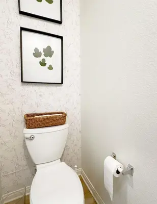 a bathroom with a toilet and a basket on the wall at Claremont Colleges And Ontairo Mills Single Villa stay more 30 nights in Upland