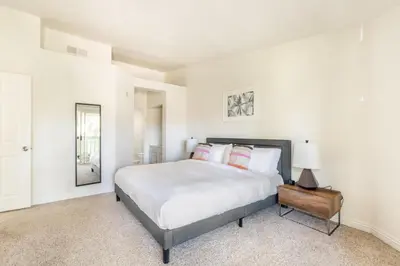 a white bedroom with a bed and a lamp at Thousand Oaks 2br near shopping dining bars LAX-1157 in Oak Park