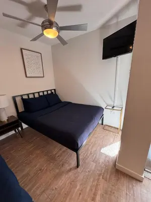 a bedroom with a bed and a ceiling fan at Hollywood Universal Studios Apartment FREE parking in Los Angeles