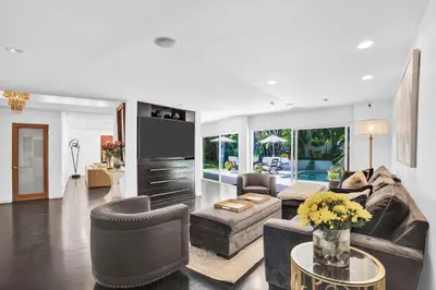 a living room with a couch and chairs and a tv at Edwin by AvantStay Hollywood Hills Luxury Pool in Los Angeles
