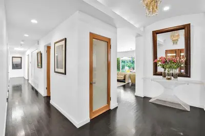 a white hallway with a vase of flowers on a table at Edwin by AvantStay Hollywood Hills Luxury Pool in Los Angeles