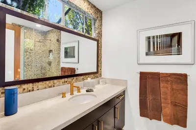 a bathroom with a sink and a large mirror at Edwin by AvantStay Hollywood Hills Luxury Pool in Los Angeles