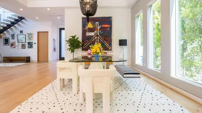 a dining room with a glass table and white chairs at Luxe WeHo Villa Walk to Melrose Ave Pool Hot Tub North Vista by AvantStay in Los Angeles