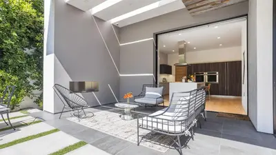 a patio with chairs and a table and a kitchen at Luxe WeHo Villa Walk to Melrose Ave Pool Hot Tub North Vista by AvantStay in Los Angeles