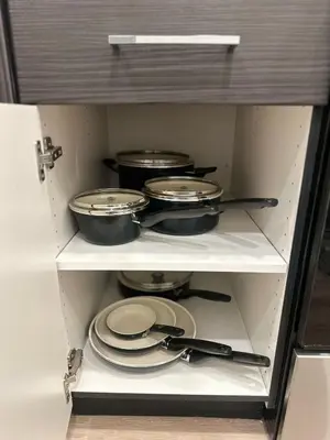 a cabinet with pots and pans and utensils in it at Cozy Loft Sunset FRRE WIFI and DESIGNATED Parking in Los Angeles