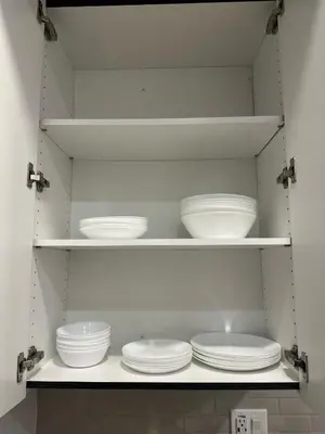 a kitchen with white plates and bowls on shelves at Cozy Loft Sunset FRRE WIFI and DESIGNATED Parking in Los Angeles