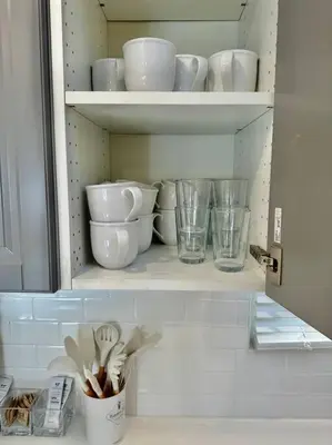 a cupboard filled with bowls and plates and glasses at Charming Zen Venice Beach 3BR Home w/Patio & W/D in Los Angeles