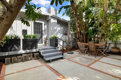 a house with a patio with a table and chairs at Charming Zen Venice Beach 3BR Home w/Patio & W/D in Los Angeles