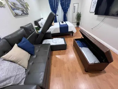 a living room with a couch and a bed at NEW! 2-Bedroom Fontana Guest House close to Kaiser Permanente in Fontana