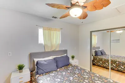 a bedroom with a bed and a ceiling fan at Crestline Home with Private Hot Tub Steps to Lake! in Crestline