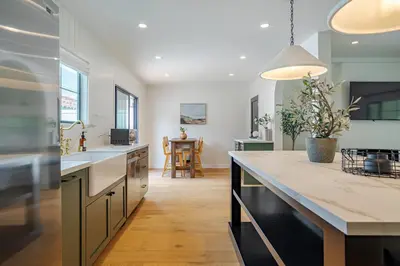 a kitchen with a large counter and a dining room at New Home Universal sleeps 18 hot tub in Los Angeles