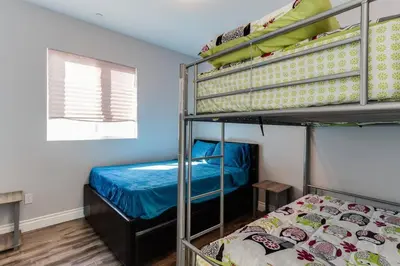 a bedroom with two bunk beds and a bed at Lake Balboa 7 Bedroom 5 Bathroom Compound in Los Angeles