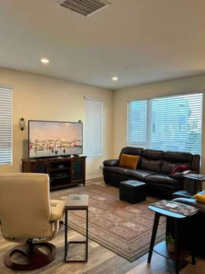 a living room with a couch and a flat screen tv at 3 Bedroom Townhome with Large Living Area in Downey