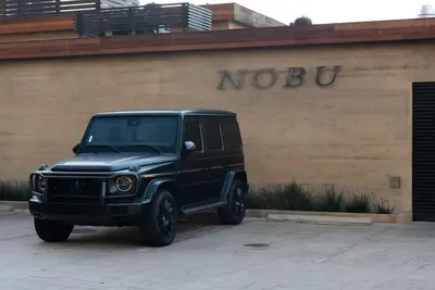 a black jeep parked in front of a building at Malibu Sand Carbon Beach Suites in Malibu