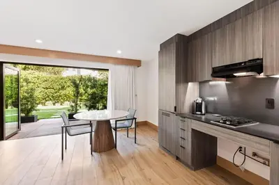 a kitchen and dining room with a table and chairs at Malibu Sand Carbon Beach Suites in Malibu