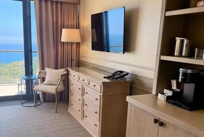 a hotel room with a television and a desk with a chair at Villa Graziadio Executive Center at Pepperdine University in Malibu