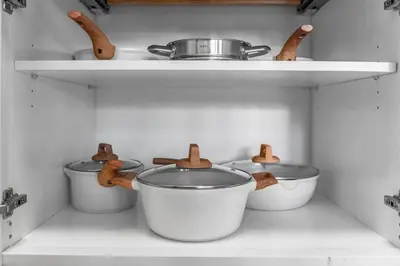 a kitchen with three pots and pans on a shelf at Stylish in Sunny Santa Monica walk to Beach & Pier in Los Angeles