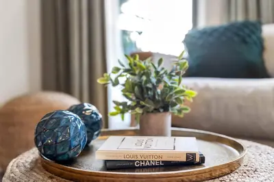 a table with books and a vase on a table at Stylish in Sunny Santa Monica walk to Beach & Pier in Los Angeles