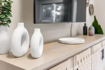four white vases are sitting on a counter at Stylish in Sunny Santa Monica walk to Beach & Pier in Los Angeles